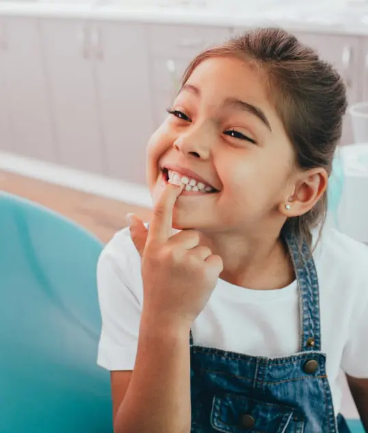 Cute Child Pointing At Her Teeth